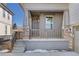 Inviting front porch with stone pillars, wood railing, and the house number prominently displayed at 17412 W 93Rd Pl, Arvada, CO 80007