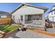 Charming single-story house featuring a cozy porch, well-kept garden beds, and stone pavers at 17412 W 93Rd Pl, Arvada, CO 80007