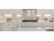 Close up on kitchen with quartz countertops and stylish backsplash at 17412 W 93Rd Pl, Arvada, CO 80007