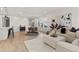 Bright, open-concept living and dining area featuring neutral walls and hardwood floors at 17412 W 93Rd Pl, Arvada, CO 80007