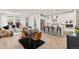 Bright, open-concept living and dining area with modern kitchen, stainless steel appliances, and hardwood floors at 17412 W 93Rd Pl, Arvada, CO 80007