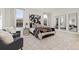 Spacious bedroom with stylish decor, including modern art and comfortable seating area at 17412 W 93Rd Pl, Arvada, CO 80007