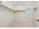 Empty walk-in closet with ample shelving and rod space for organized storage at 17412 W 93Rd Pl, Arvada, CO 80007