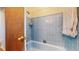 Bathtub shower combination with blue tiling and a shower head at 2230 Miller Ct, Lakewood, CO 80215