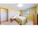 Bedroom features a bed, a window with blinds, and light yellow walls at 2230 Miller Ct, Lakewood, CO 80215