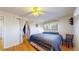 Cozy bedroom features wood floors, ceiling fan, and a large bed with blue comforter at 2230 Miller Ct, Lakewood, CO 80215