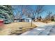 A charming home with an attached garage, landscaped yard, and inviting curb appeal at 2230 Miller Ct, Lakewood, CO 80215