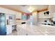 Well-lit kitchen featuring white cabinets, tile countertops, and modern appliances at 2230 Miller Ct, Lakewood, CO 80215