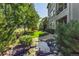 Landscaped backyard with lush lawn, mature trees, rock water feature, and cozy seating area at 2980 Craig Ct, Castle Rock, CO 80109