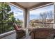 Cozy outdoor balcony with wicker furniture and views of the neighborhood at 2980 Craig Ct, Castle Rock, CO 80109