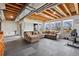 Spacious basement area featuring a large sectional sofa and a workout area with large windows at 2980 Craig Ct, Castle Rock, CO 80109