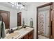 Bathroom featuring double sinks and decorative tile accents with a shower at 2980 Craig Ct, Castle Rock, CO 80109