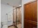 Bathroom featuring a glass-enclosed tiled shower with built-in bench and a convenient towel rack at 2980 Craig Ct, Castle Rock, CO 80109