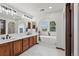 Bright bathroom features dual sinks, a soaking tub under an arched window, and a separate shower at 2980 Craig Ct, Castle Rock, CO 80109