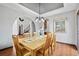 Dining area has wooden table and view to living room featuring modern light fixture at 2980 Craig Ct, Castle Rock, CO 80109