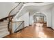 Grand foyer features a curved staircase, hardwood floors and dining room with abundant sunlight at 2980 Craig Ct, Castle Rock, CO 80109
