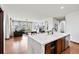 Open concept living area featuring a kitchen island with quartz countertop at 2980 Craig Ct, Castle Rock, CO 80109