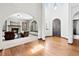 Open concept living room featuring a stone fireplace, wood windows and hardwood floors at 2980 Craig Ct, Castle Rock, CO 80109
