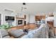 Inviting living room with a stone fireplace, open kitchen, and hardwood floors at 2980 Craig Ct, Castle Rock, CO 80109