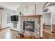 Cozy living room features a stone fireplace, hardwood floors, and recessed shelving at 2980 Craig Ct, Castle Rock, CO 80109