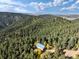 Scenic aerial view of the house, highlighting its integration with the surrounding natural landscape and mountain views at 2785 Magpie Ln, Larkspur, CO 80118
