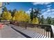 Spacious back deck, perfect for outdoor entertaining and enjoying the surrounding wooded views at 2785 Magpie Ln, Larkspur, CO 80118