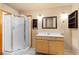 Bathroom featuring tile floors, a standing shower, a vanity with a sink, and wood accents at 2785 Magpie Ln, Larkspur, CO 80118