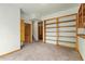 Carpeted bedroom with built-in shelving and trim at 2785 Magpie Ln, Larkspur, CO 80118