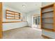 Bright bedroom with built-in shelving and a sliding glass door to the outside at 2785 Magpie Ln, Larkspur, CO 80118