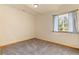 Bedroom featuring a window with curtains and neutral walls at 2785 Magpie Ln, Larkspur, CO 80118