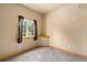 Neutral bedroom featuring a window with wood trim and gray carpet at 2785 Magpie Ln, Larkspur, CO 80118