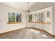 A charming dining room, surrounded by natural light coming from the windows, features carpeted floors at 2785 Magpie Ln, Larkspur, CO 80118