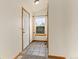 Well-lit entryway featuring tile flooring, a large white door, and backyard views from the window at 2785 Magpie Ln, Larkspur, CO 80118