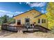 Charming home with a welcoming porch and beautiful landscaping, set against a backdrop of lush greenery at 2785 Magpie Ln, Larkspur, CO 80118