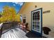 Charming front porch with bench seating, potted flowers, and a welcoming entrance to the home at 2785 Magpie Ln, Larkspur, CO 80118
