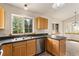 Bright kitchen featuring wood cabinets, stainless steel appliances, and a double sink with a large window at 2785 Magpie Ln, Larkspur, CO 80118