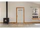 A living room featuring a wood stove, a door and a window which has a view to nature outside at 2785 Magpie Ln, Larkspur, CO 80118