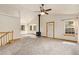 An airy living room which has wood trim on the ceiling, windows and a wood burning stove at 2785 Magpie Ln, Larkspur, CO 80118
