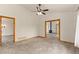 Spacious living room with neutral carpet, wood trim, and views into other rooms with lots of natural light at 2785 Magpie Ln, Larkspur, CO 80118
