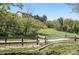 View of the backyard and fence leading to a vast green space at 7276 Brighton Ct, Castle Pines, CO 80108