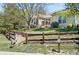 Backyard view showcasing a wooden fence, brickwork, mature trees, and lush landscaping at 7276 Brighton Ct, Castle Pines, CO 80108