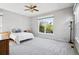 Spacious bedroom with a large window, ceiling fan, and neutral decor offering a serene retreat at 7276 Brighton Ct, Castle Pines, CO 80108