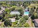 Aerial view showcasing the community's tennis courts, basketball court, pool, and lush landscaping at 7276 Brighton Ct, Castle Pines, CO 80108