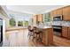 Bright kitchen with center island, wood cabinets, and natural light at 7276 Brighton Ct, Castle Pines, CO 80108
