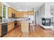 Bright kitchen with stainless steel appliances, center island and an open floorplan to the living room at 7276 Brighton Ct, Castle Pines, CO 80108