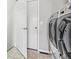 Laundry room with modern, stainless steel washer and dryer at 7276 Brighton Ct, Castle Pines, CO 80108
