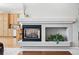 A fireplace with mantel serves as the focal point of the living room at 7276 Brighton Ct, Castle Pines, CO 80108