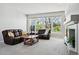 Living room with plush furniture, large windows, and a cozy fireplace feature at 7276 Brighton Ct, Castle Pines, CO 80108