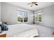 Bright main bedroom with two windows, ceiling fan, carpet and neutral paint at 7276 Brighton Ct, Castle Pines, CO 80108