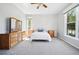 Large main bedroom featuring neutral carpet, ceiling fan and two large windows at 7276 Brighton Ct, Castle Pines, CO 80108